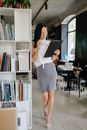 Woman in White Dress Holding Black Book