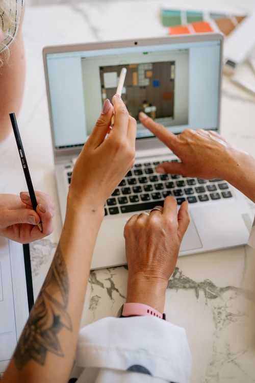 Hand Pointing on the Laptop Screen · Free Stock Photo