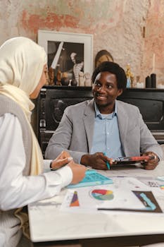 A man and woman engaging in a productive business meeting in a stylish office setting.