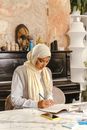 Woman Writing on Notebook