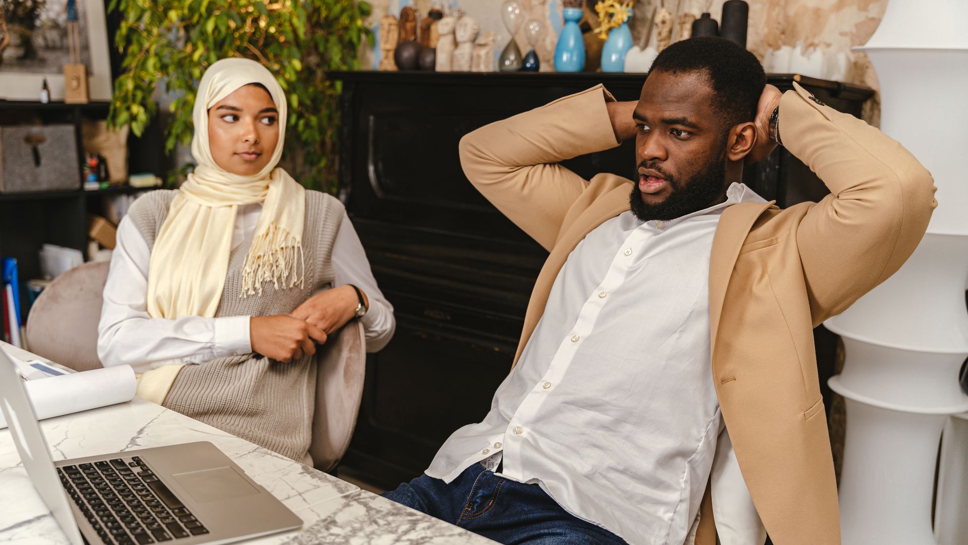 Modafinil for Remote Workers: Boost Productivity and Focus Two diverse colleagues engaging in a thoughtful discussion in a modern office setting — modafinil for remote workers