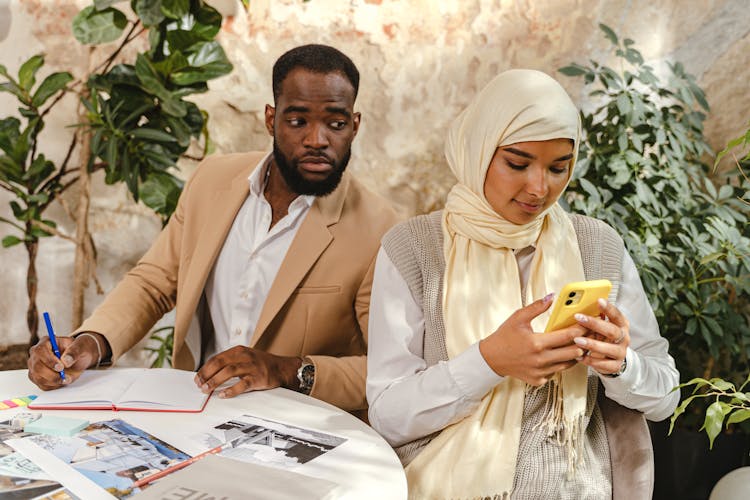 Man Peeking At Woman Smartphone