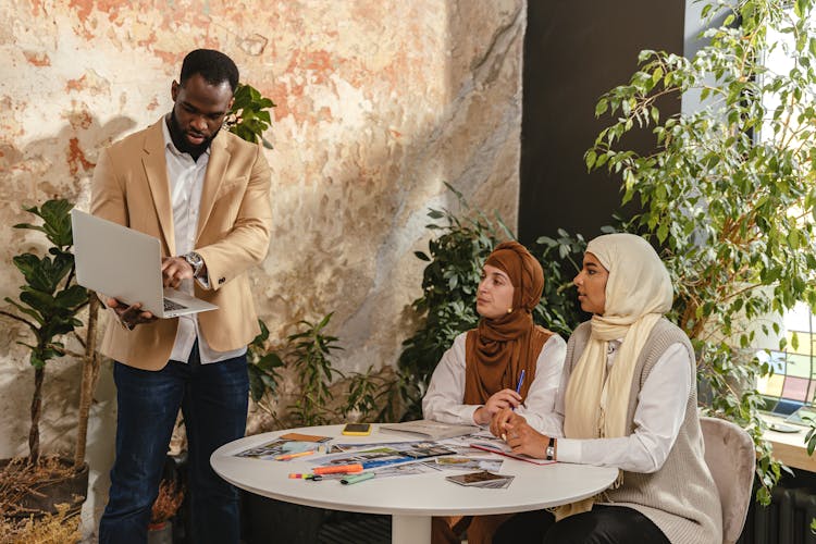 A Man Making A Business Presentation To Women