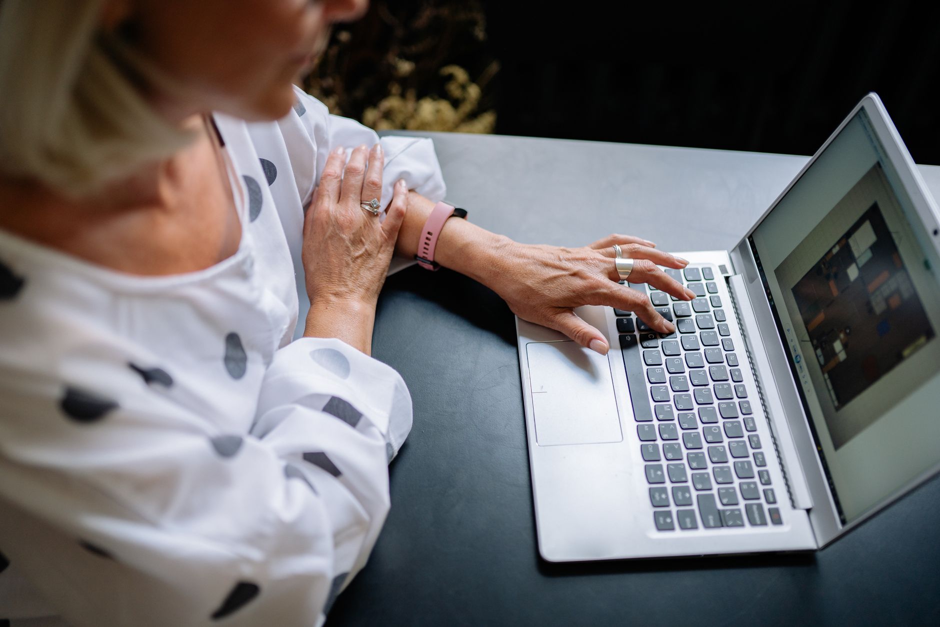 Person in Polka Dot Long Sleeves Working on a Laptop