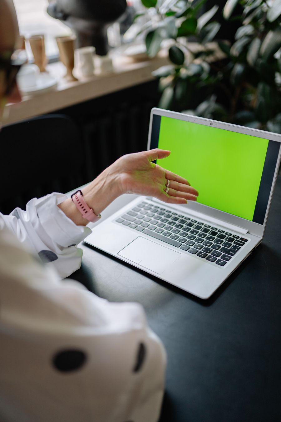 Person pointing at a laptop screen