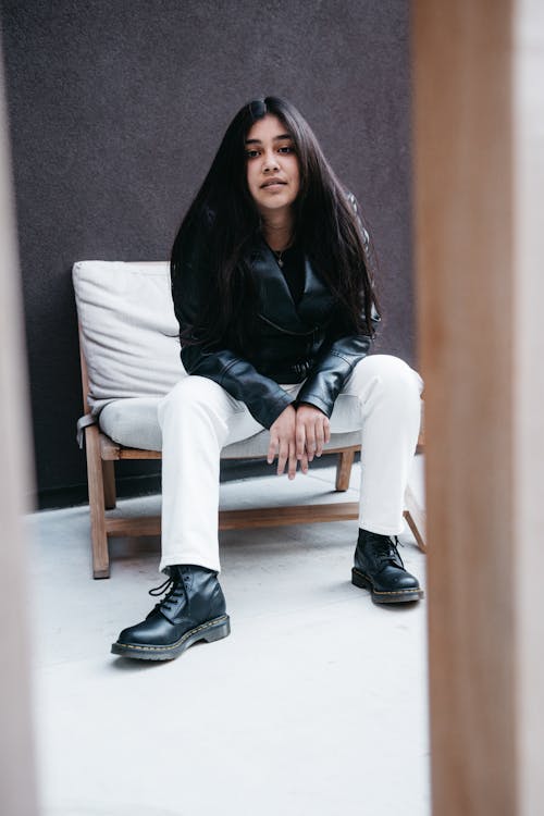 Woman Sitting on Chair Wearing Casual Clothing