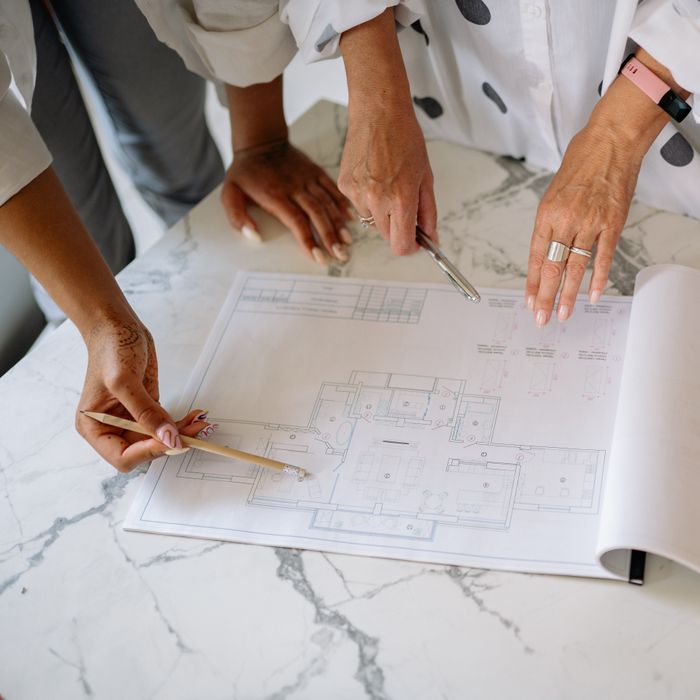 Reviewing printed plans across the big table — photo by Yan Krukau on Pexels