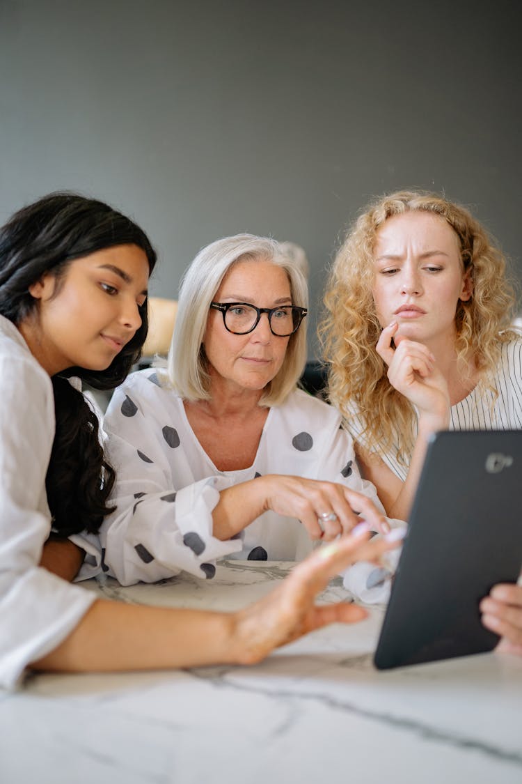 Women Looking At The Screen Of A Tablet