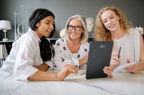 Free Women Having a Meeting While Smiling Stock Photo