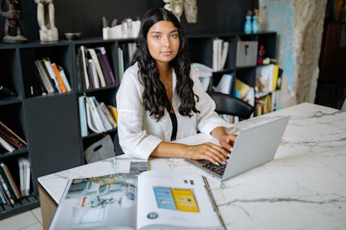 A Woman Using Laptop at the Office