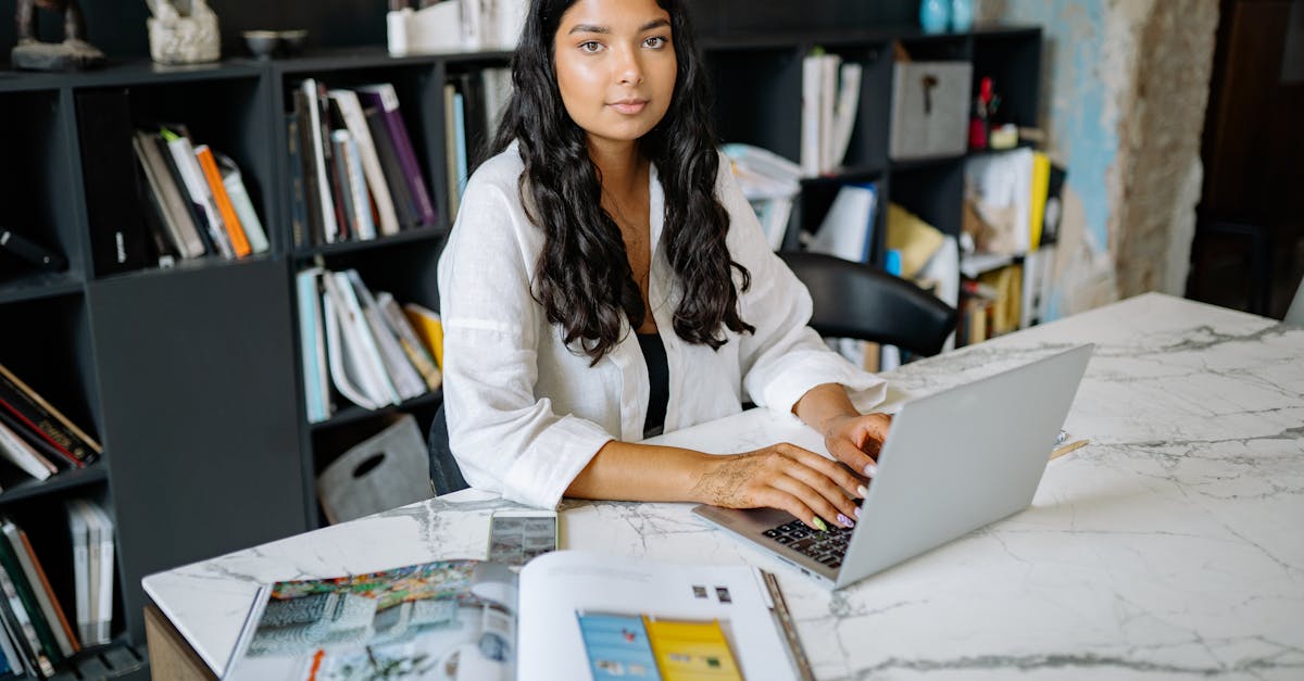 A product professional working from a minimalist marble office desk