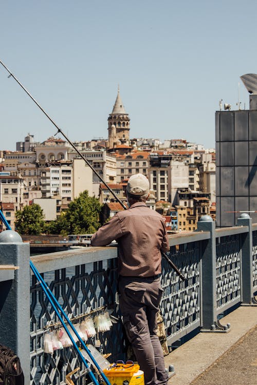 A Man Fishing on the Bridge