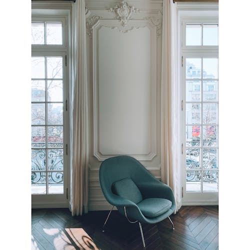 A Teal Chair inside the House