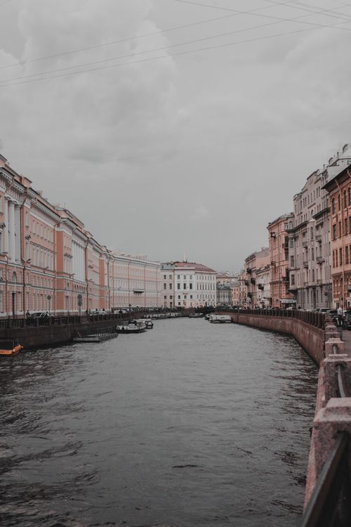 Free Atmospheric view of a canal lined with historic facades in a European city. Stock Photo