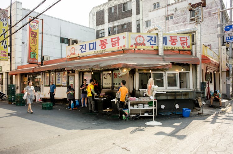 People Relaxing By Small Restaurant In Korea