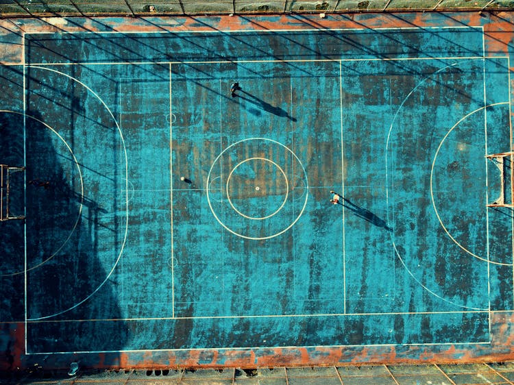 Boys Playing Football On Field