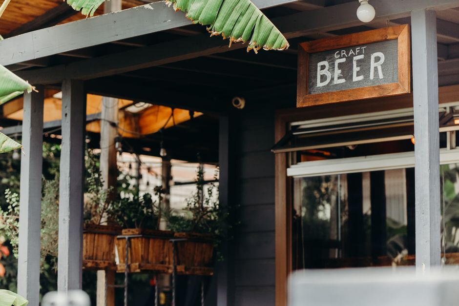 A charming craft beer pub exterior with lush greenery in San Diego, California.