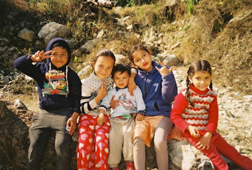 Group of Children Sitting on Rock