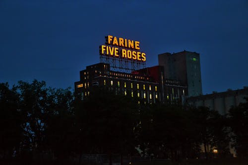 Illuminated Sign of the Farine Five Roses Building at Night in Montreal, Quebec, Canada 