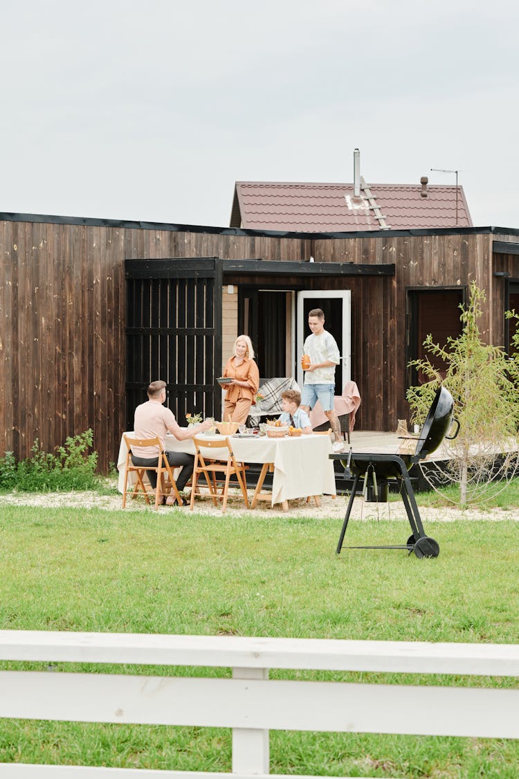 Family Having Dinner In Yard