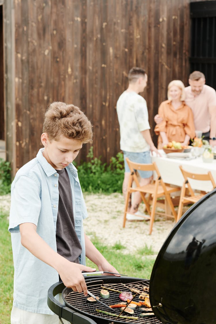 A Boy Grilling Food 