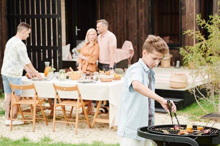 A Boy Grilling Food 