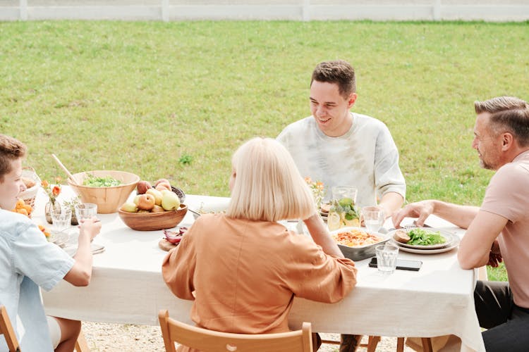 A Family Eating Outdoors Together