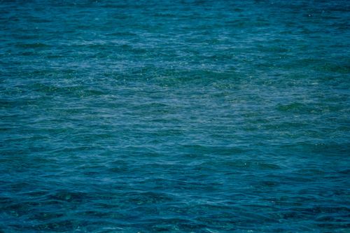 Free Serene ocean view capturing calming blue water ripples on a sunny day. Stock Photo
