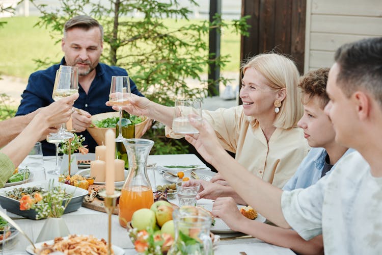 A Family Eating Outside In The Backyard