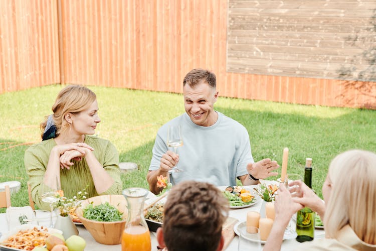 A Family Eating At The Backyard 