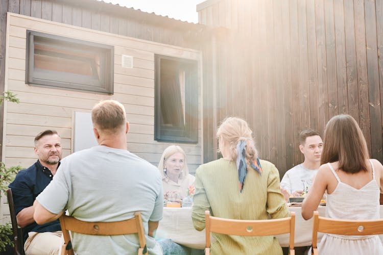 A Family Eating Lunch In The Backyard