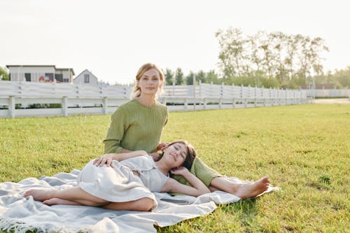Free Women Resting on a Picnic Blanket Stock Photo