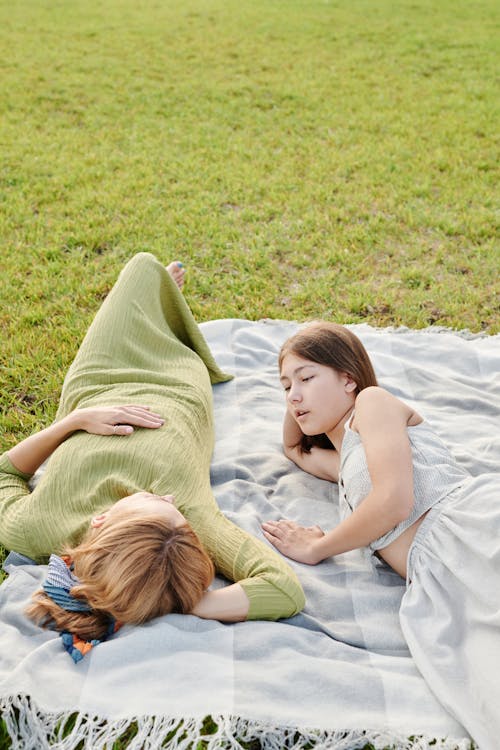 Mother and Daughter Lying on the Picnic Blanket 