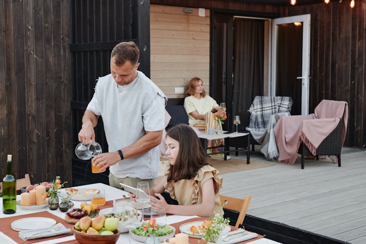 A Family  Having Eating In Their Backyard