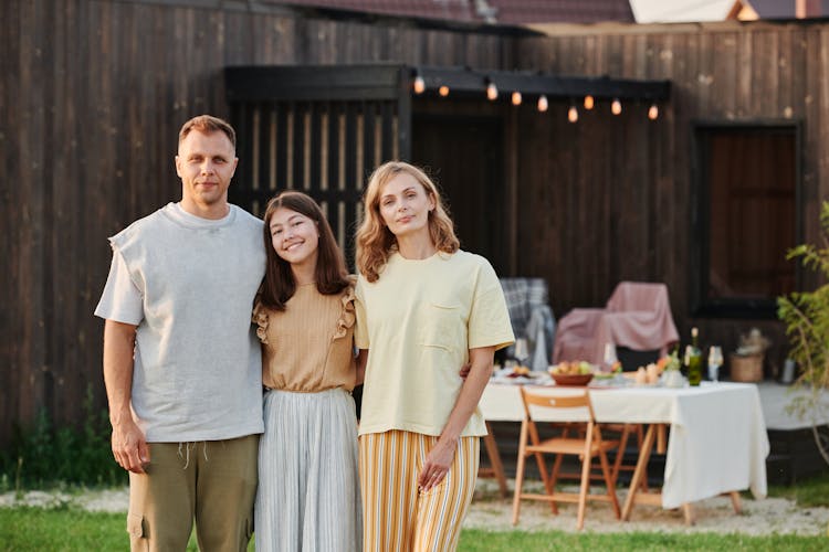 A Family Posing With Arms Around Each Other