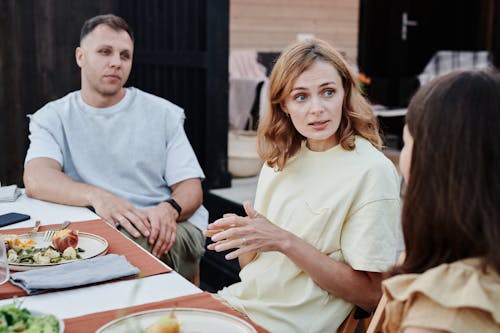 Free A Man and Woman Sitting at the Table Stock Photo