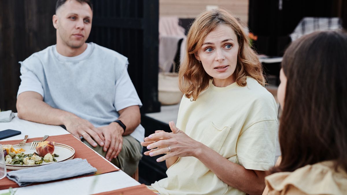A group of adults enjoying a relaxed outdoor meal together.