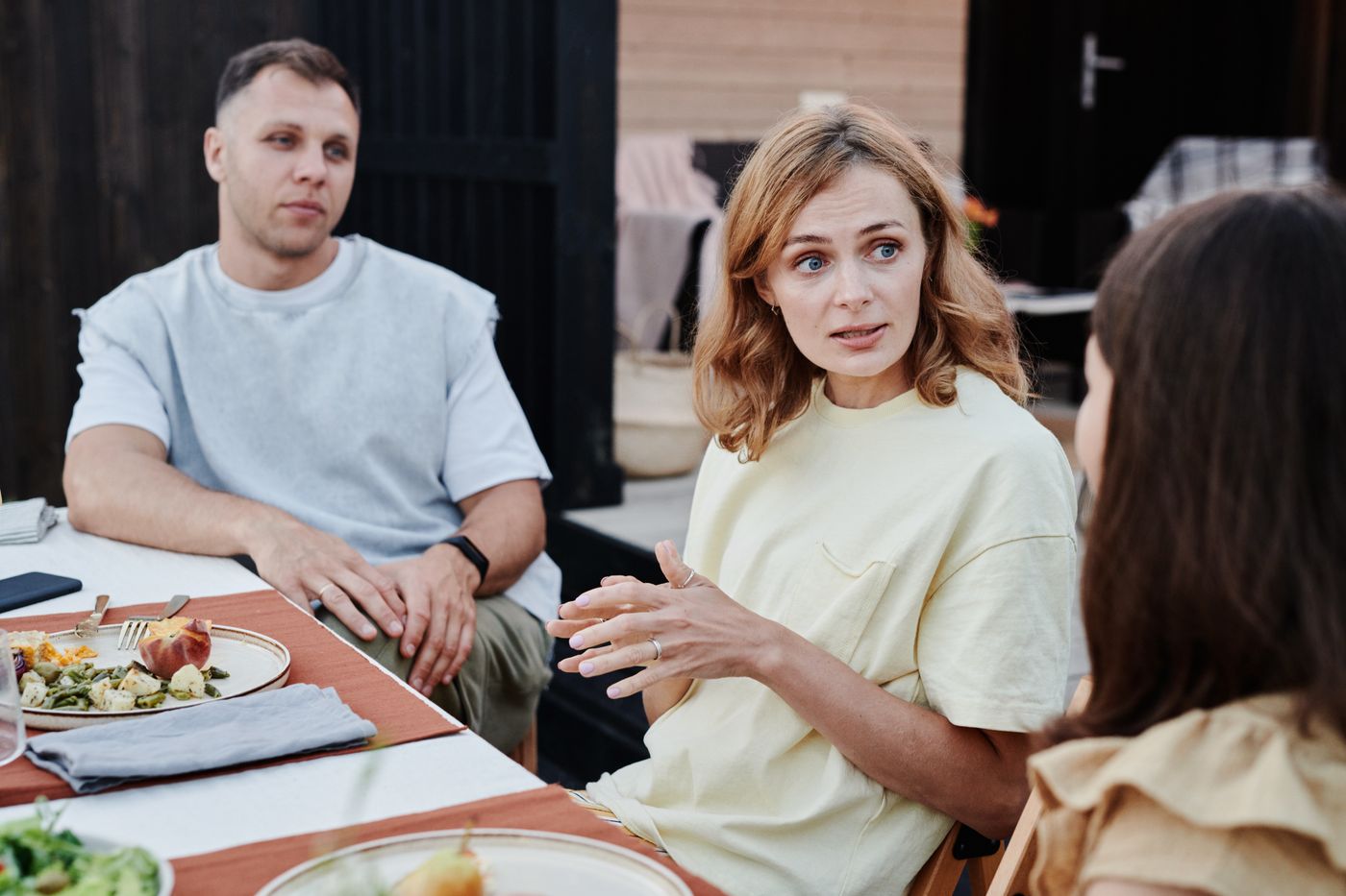 Family talking together around the dinner table