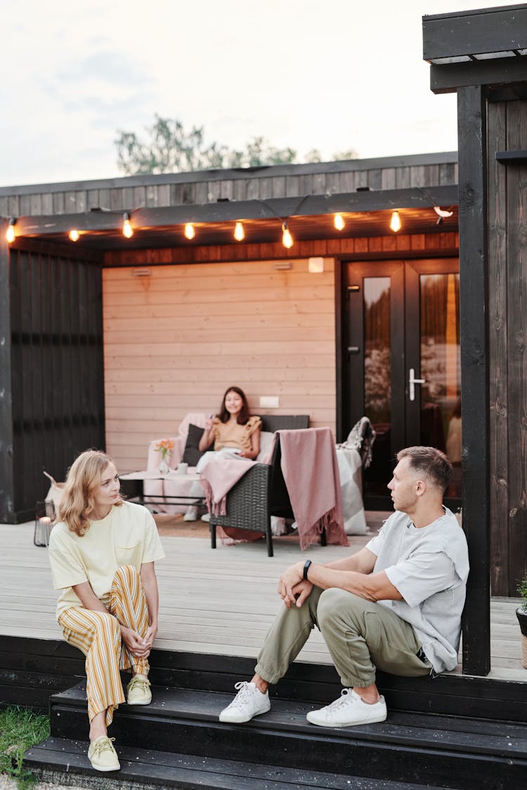 A Family Sitting On Their Home Patio