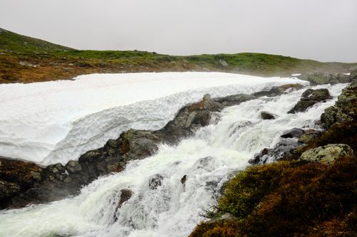 Free Snow-covered cascade in Beitostølen, Norway captures winter's serene beauty. Stock Photo