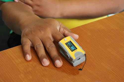 A Person Wearing a Pulse Oxygen Meter