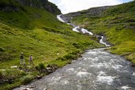 People Walking Near a River