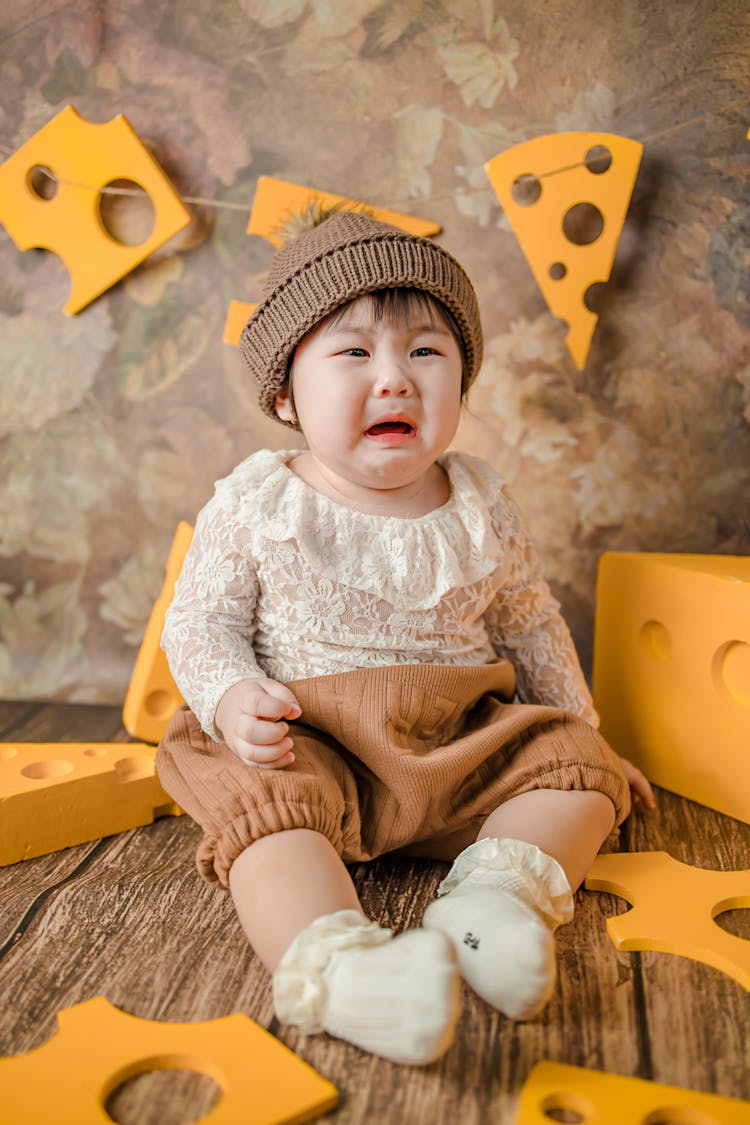 Toddler Wearing Brown Beanie Crying