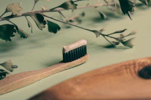 Free Close-Up Shot of a Wooden Toothbrush with a Toothpaste Stock Photo