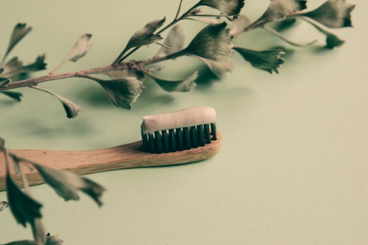 A Natural Wooden Toothbrush With Toothpaste