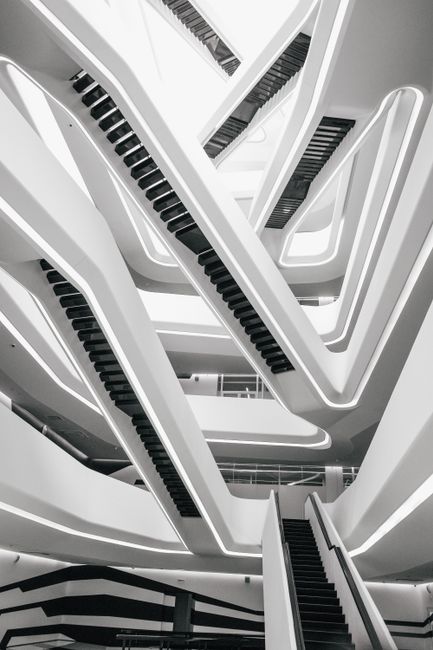 A striking vertical shot of modern geometric staircase design in a building, showcasing intricate architecture.