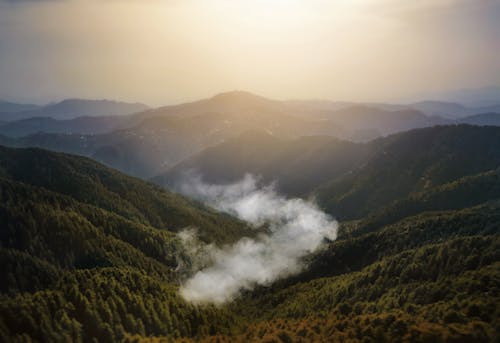 Foggy Green Mountains Under White Sky