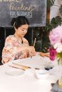 Woman Drawing using a Paintbrush