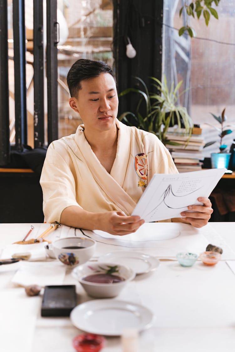 Man Looking At Drawings