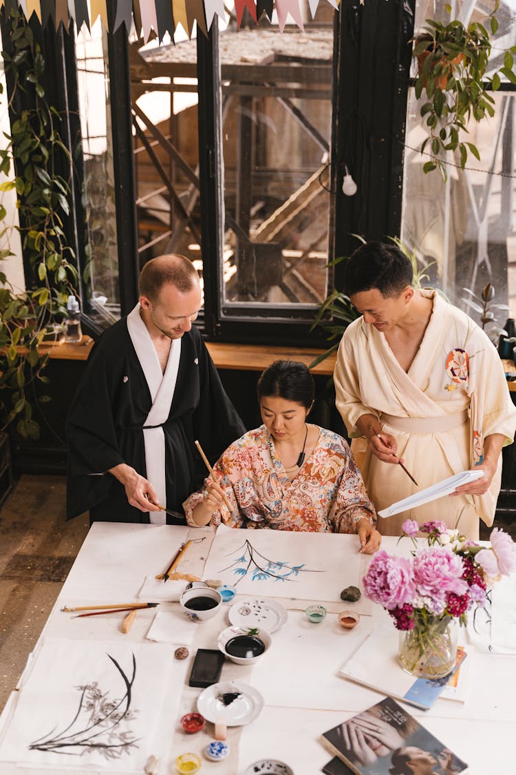 People Wearing Traditional Kimonos Practicing Japanese Art 